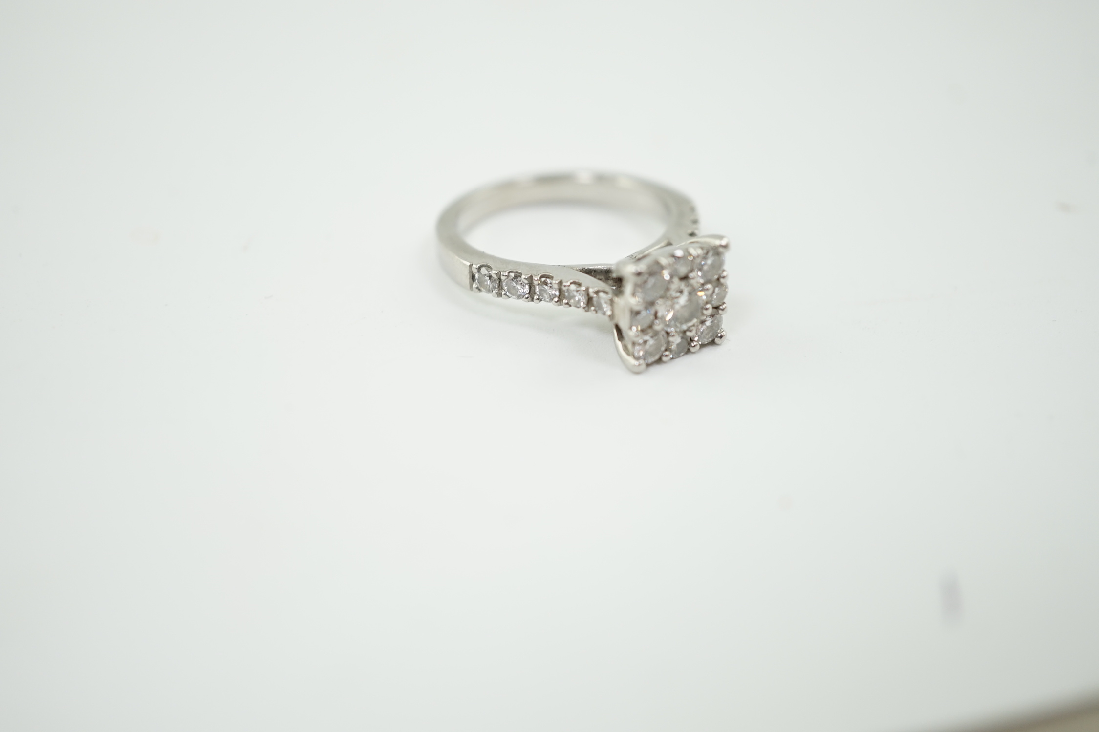 A modern platinum and nine stone diamond set square cluster ring